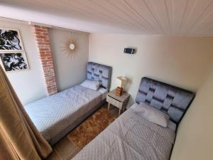 a small bedroom with two beds and a table at Essaouira I in Essaouira