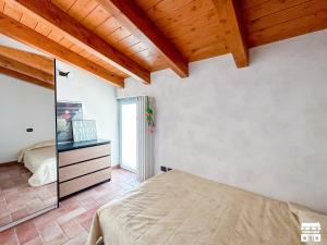 a bedroom with a bed and a mirror at MAMMA MIA by Design Studio in Bellano
