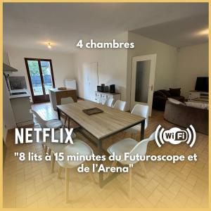 a kitchen and a living room with a table at Maison paisible, 15 min du Futuroscope & Arena. in Fontaine-le-Comte