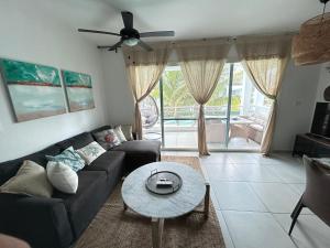 a living room with a couch and a table at Atmospheric apartment with a beautiful view of the swimming pool in Bayahibe