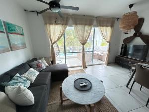 a living room with a couch and a table at Atmospheric apartment with a beautiful view of the swimming pool in Bayahibe