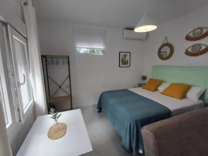 um quarto com uma cama e um sofá em Casa del Arco em Olvera