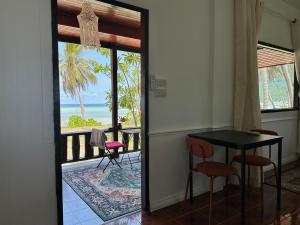 a dining room with a view of the ocean at Beachfront house in Chaloklum in Mae Haad