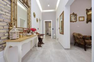 a hallway with a stone wall and a table and chairs at Roman Holiday Suites in Rome +106 photos