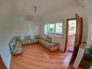 a living room with a couch and a window at Villa La Palma 2, Imi ouaddar in Agadir nʼ Aït Sa