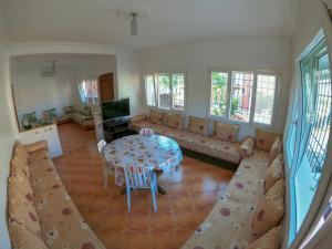 a living room with a couch and a table at Villa La Palma 2, Imi ouaddar in Imi Ouaddar