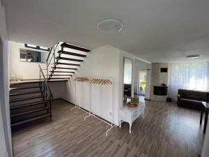 a living room with a spiral staircase in a house at Green Hills Sibiu in Sibiu