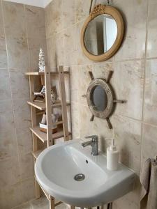 a bathroom with a sink and a mirror at Green Hills Sibiu in Sibiu +29 photos