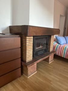 a brick fireplace in a room with a bed at Studio à Noyarey avec wifi in Noyarey