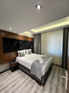 a bedroom with a large bed and a large window at Golden Stone Hotel in Istanbul