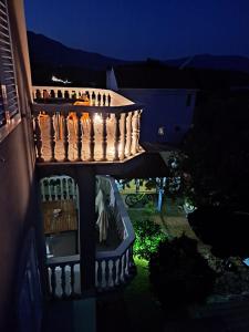 a group of people sitting on a balcony at night at Sea View Apartment Amaro in Korčula