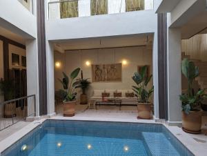 a house with a swimming pool and a living room at Dar d'Art in Marrakesh