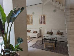 a living room with a couch and a table at Dar d'Art in Marrakesh +114 photos