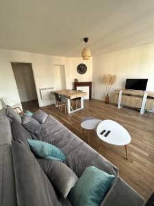 a living room with a couch and a table at Appartement centre d Arcis in Arcis-sur-Aube