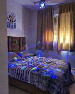 a bedroom with a bed with blue lights on it at Marrakech Alal fasi in Marrakesh