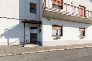 a white building with a door and a balcony at Nido di Stella in Zanica