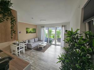 a living room with a couch and a table at Haus am Brunnen Wohnung 1 in Klosterkumbd