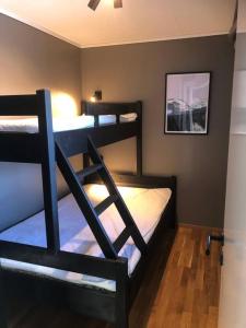 a bedroom with three bunk beds in a room at Leilighet i Oppdal - 4 soverom, 2 stuer og 2 bad in Oppdal