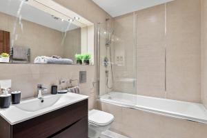 a bathroom with a sink and a toilet and a shower at Designer Apartment in Central Lincoln - Flat 8 in Lincolnshire