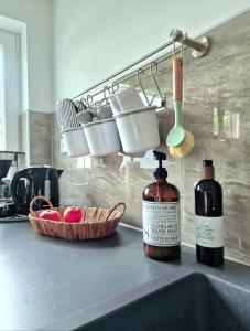 a kitchen counter with a sink with a bottle of wine at Kieler Eiderparadies in Flintbek