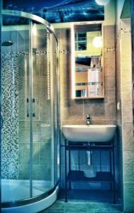 a bathroom with a sink and a shower at Apt bright, quiet! In the center. in Florence