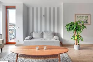 a living room with a couch and a coffee table at CLASSY APARTMENTS - Gdynia - Słoneczne Wzgórze in Gdynia +32 photos