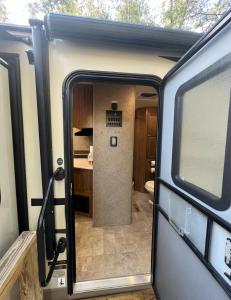 an open door of an rv with a kitchen inside at Sunrise Hideaway in Crystal River