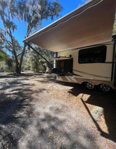 an rv parked in a gravel parking lot at Sunrise Hideaway in Crystal River
