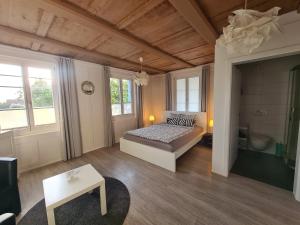 a large room with a bed and a bathroom at von May Rooms in Herbligen 