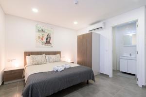 a bedroom with a bed with two towels on it at Host Wise Arvore in Vila do Conde