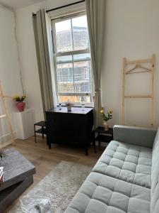 a living room with a couch and a window at Islington Apartments in London