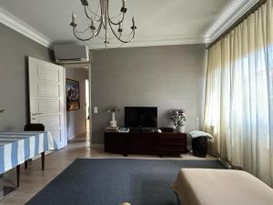 a living room with a bed and a television at Casa do João • City Break • Lisbon in Lisbon