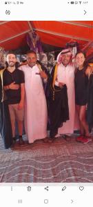 Desert star camp في وادي رم: مجموعة من الناس في ملابس متنكرين لالتقاط صورة