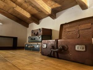 a pile of suitcases sitting on the floor in a room at Tiny House - Lake Maggiore -Malpensa Airport - in Varallo Pombia