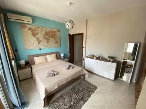 a bedroom with a bed and a map on the wall at Terra Comfort Stay in Alexandroupoli