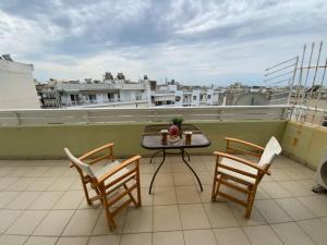 a balcony with a table and chairs on a roof at Terra Comfort Stay in Alexandroupoli