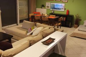 a living room with a couch and a dining room at Terra Comfort Stay in Alexandroupoli