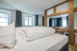 a bedroom with a large bed with white sheets at Haus Ella in Stühlingen