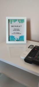 a counter with a remote control and a sign at Menrat in Novi Sad