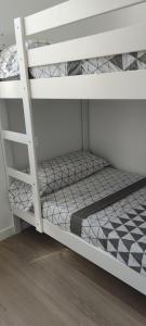 a white bunk bed with a ladder on it at Precioso apartamento de diseño para 4-6 personas VT-55212-V in Valencia