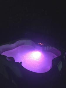 a purple light is lit up in the dark at Tillie Creek Retreat: a Creekside Oasis in Wofford Heights