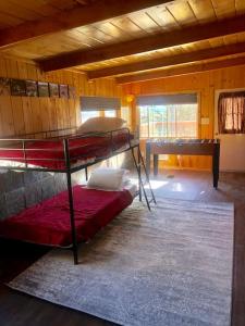 a room with two bunk beds in a cabin at Tillie Creek Retreat: a Creekside Oasis in Wofford Heights
