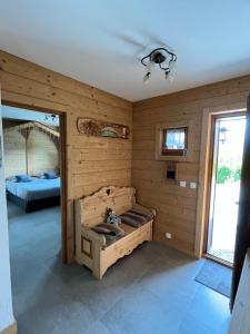 a room with a wooden wall with a bed in it at Chalet coup de coeur in Passy