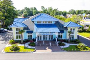 an aerial view of a resort building with a blue roof at Grand Palms Resort in Myrtle Beach