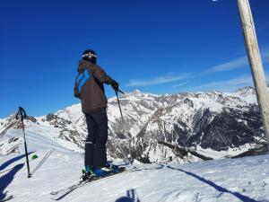 a man standing on top of a snow covered mountain at Ferienhaus Resinger in Matrei in Osttirol +29 photos