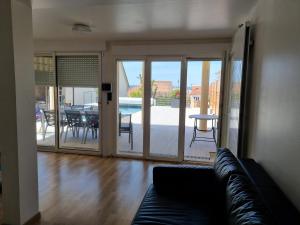 a living room with a couch and a patio at Ravissant Studio avec parking privé et jardin in Rueil-Malmaison