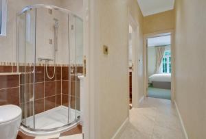 a bathroom with a shower and a toilet and a sink at Noel Oasis : London Retreat in London