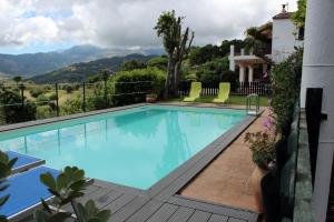 a swimming pool with a view of a house at Villa Eleanto in Cefalù