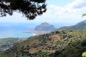 a view of a mountain with the ocean in the background at Villa Eleanto in Cefalù