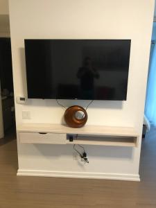 a flat screen tv on a white entertainment center at Sanctuary in Toronto's centre in Toronto